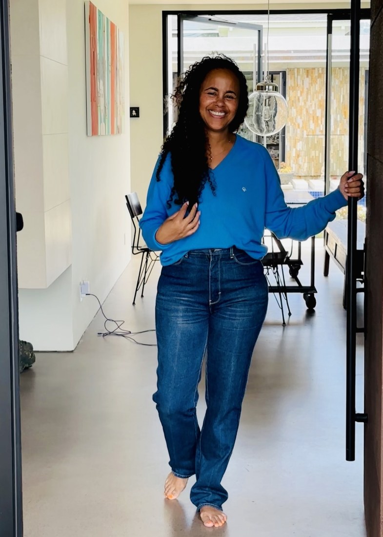 Model in blue sweater vintage jeans